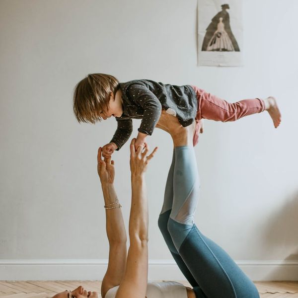 Person holding a balancing yoga pose with strong focus.
